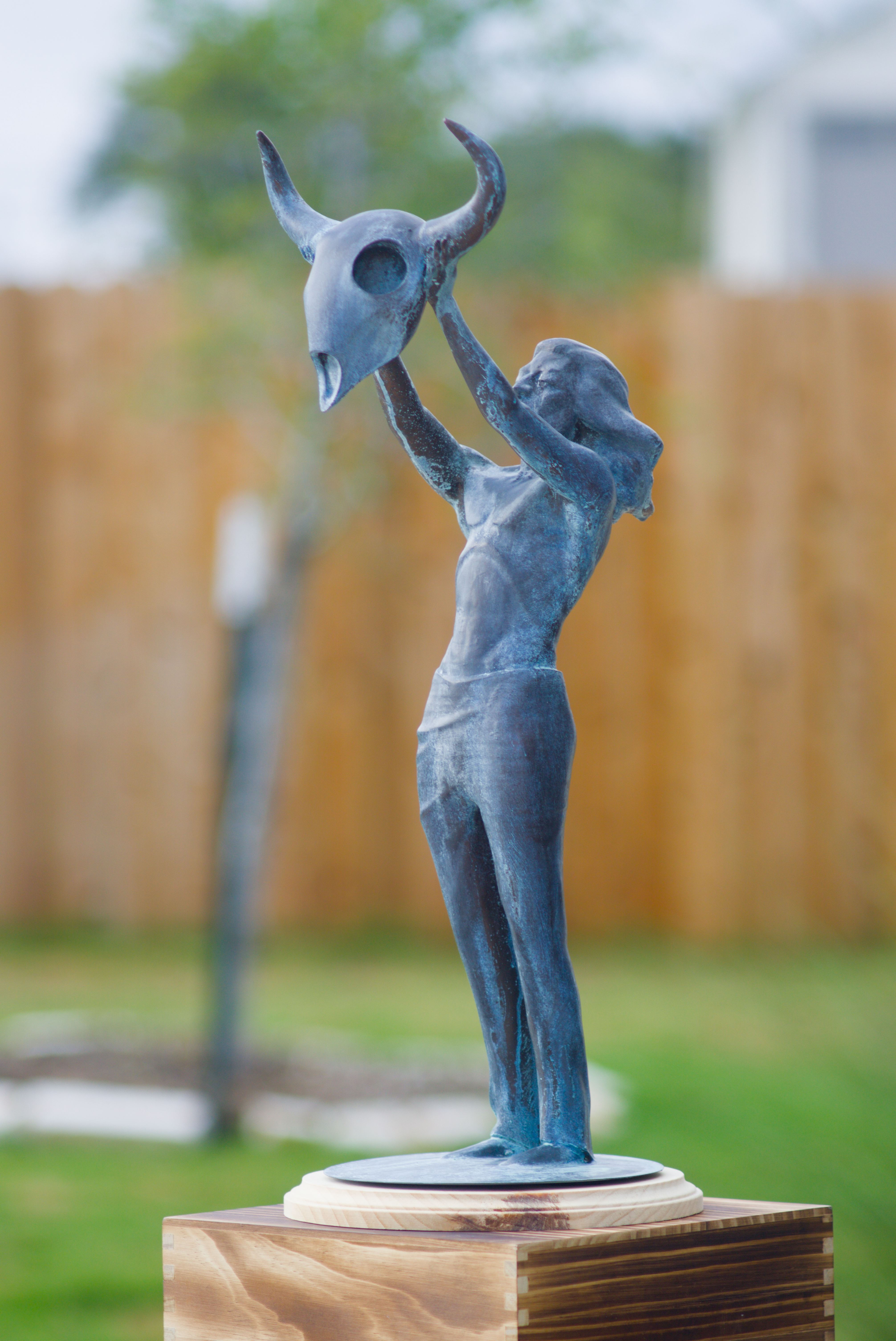 Thankful Heart figure raising an animal skull overhead